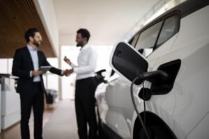 Dealer sells electric SUV to businessman in car dealership